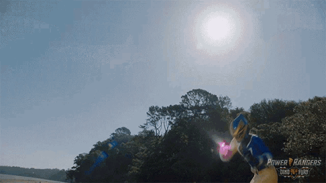 a power rangers poster with the sun shining brightly behind him