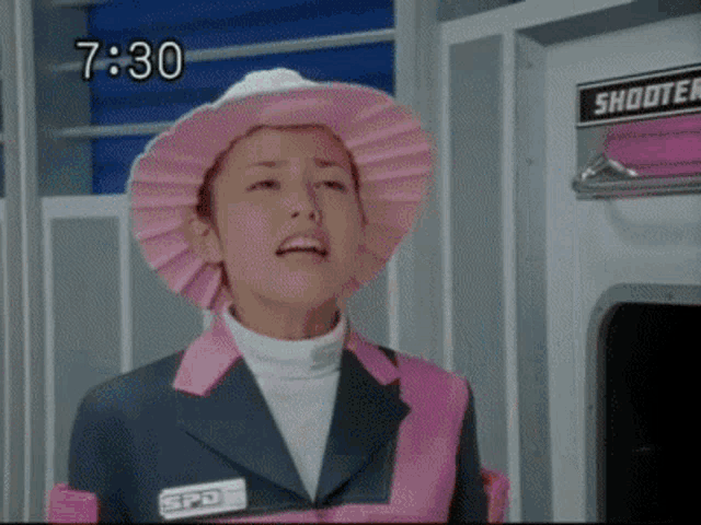 a woman wearing a pink hat with the time 7:30