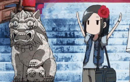 a girl is standing in front of a statue of a lion .