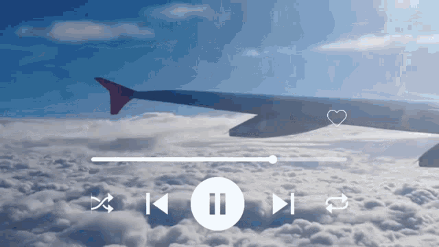 an airplane is flying through the clouds with a heart on it 's tail