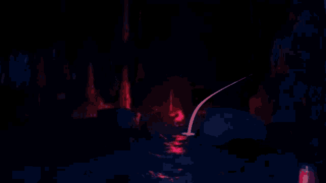 a person standing in a dark room with a red light shining on them