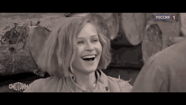 a woman is laughing in a black and white photo with the word " russia " on the bottom left