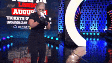 a woman wipes her nose in front of a screen that says august 5