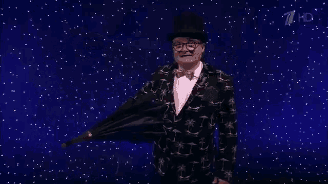a man in a top hat and glasses holds an umbrella in the rain