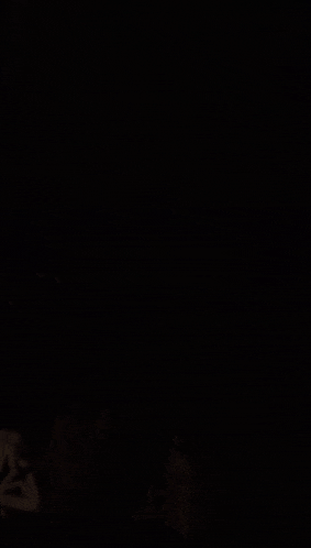 a man smoking a cigarette in the dark