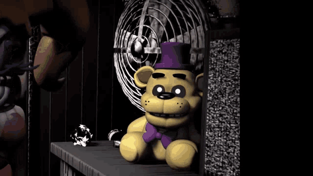 a teddy bear wearing a purple top hat is sitting on a shelf next to a fan