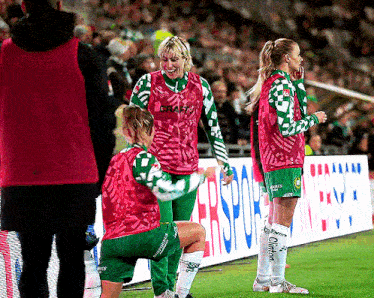 a group of female soccer players are standing in front of a banner that says ' erspor ' on it