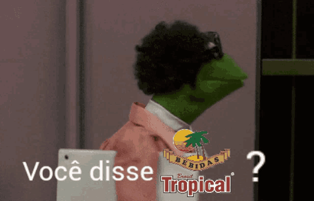 a frog with a pink shirt and a tropical logo behind him