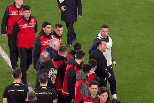 a group of men on a soccer field with one wearing a shirt that says ' istanbul ' on the back