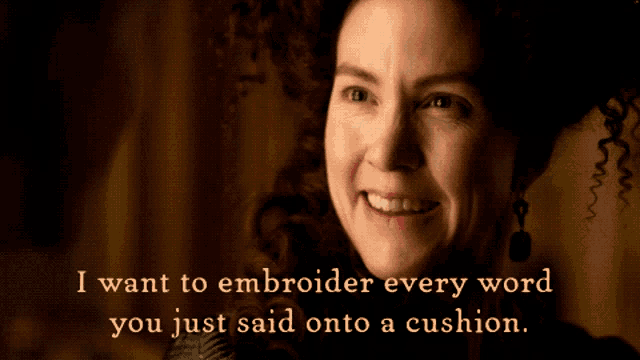a woman winks with the words i want to embroider every word you just said onto a cushion behind her