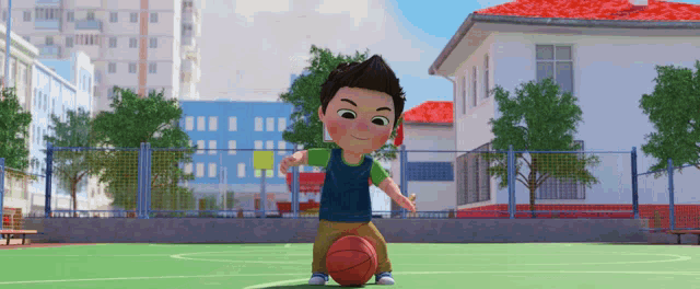 a boy in a blue shirt is playing with a basketball on a court