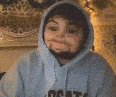 a person wearing a blue hoodie is making a funny face with their mouth open .