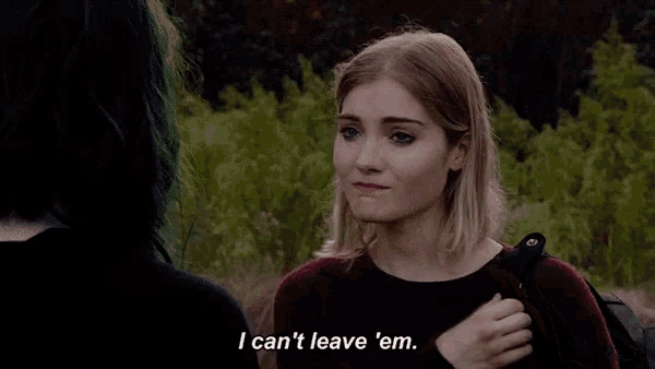 a woman with green hair is talking to another woman and says `` i can 't leave em . ''