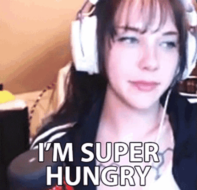 a woman wearing headphones with the words " i 'm super hungry " on the bottom