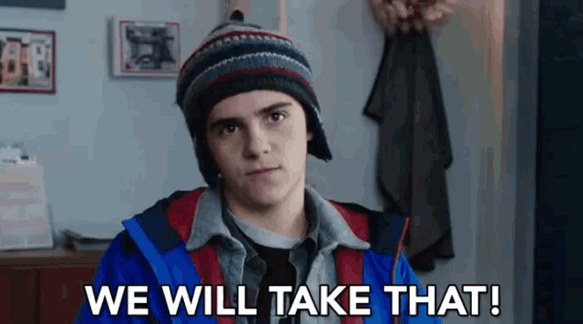 a young boy wearing a hat and a jacket says we will take that