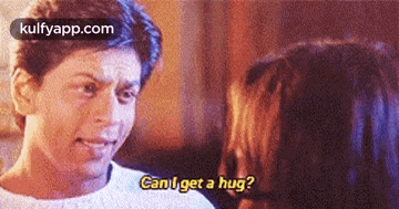 a man is talking to a woman and asking her if she can get a hug .