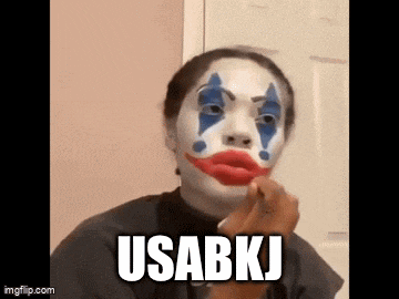 a woman is wearing a clown mask and applying makeup .