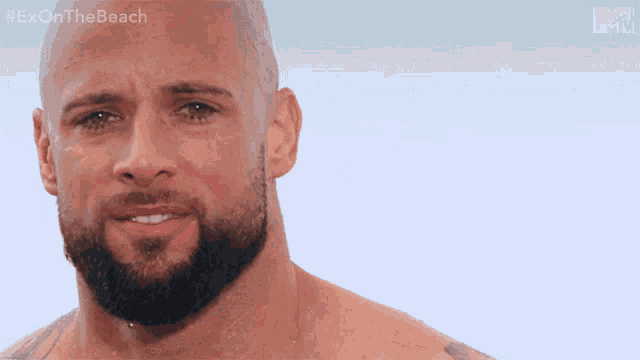 a shirtless man with a beard is crying with the hashtag #exonthe beach on the bottom