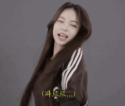 a woman with long hair is wearing a black adidas jacket