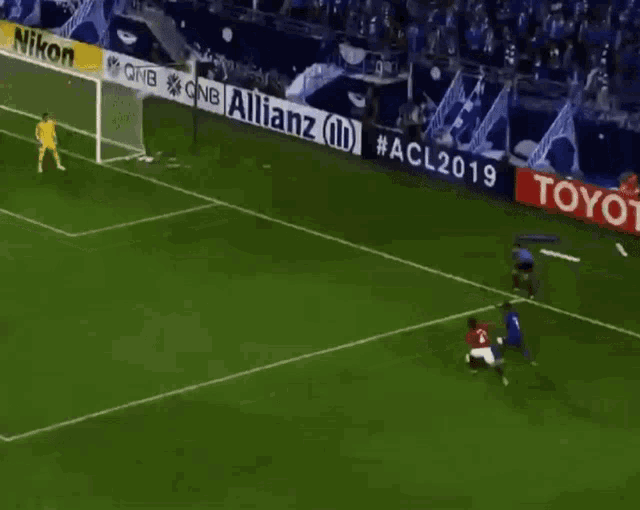 a soccer game is being played in front of a banner for allianz