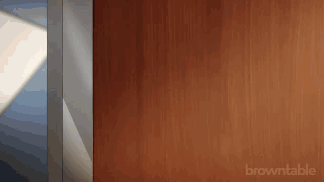 a cartoon character peeking out from behind a door that says browntable on it