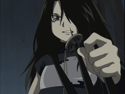 a girl with long black hair is holding a necklace with the letter s on it