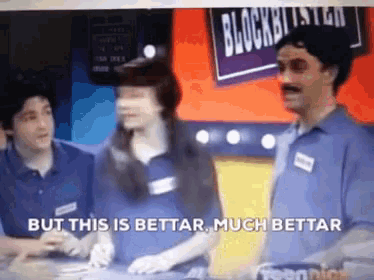 a group of people standing in front of a sign that says " but this is better "
