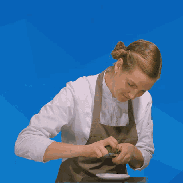 a woman wearing an apron that says s on it