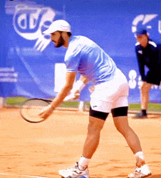 a man is holding a tennis racquet on a court in front of a banner that says ars