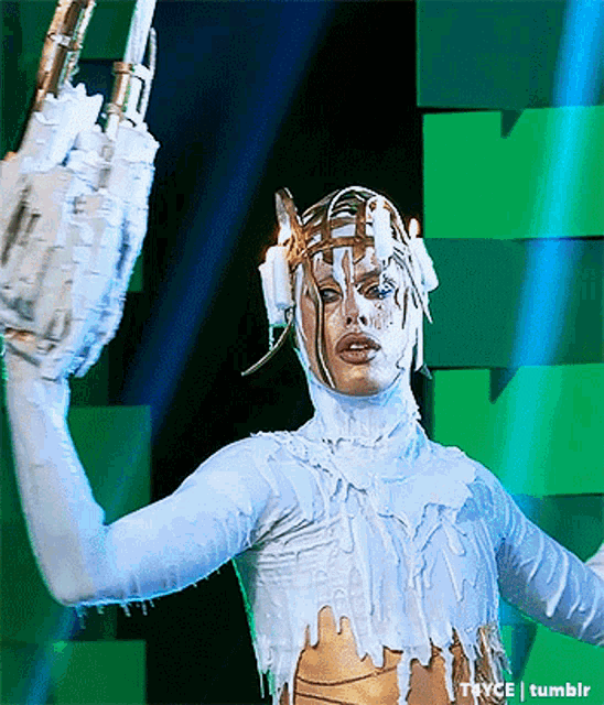 a person in a white and gold costume with tryce tumblr in the corner