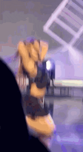 a person is holding a stuffed animal in their hand in front of a stage .