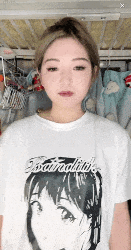 a woman wearing a white t-shirt with a picture of a girl 's face on it