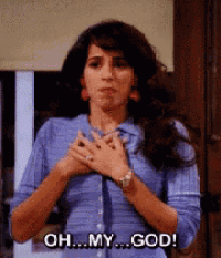 a woman in a blue shirt is holding her hands to her chest and says oh my god