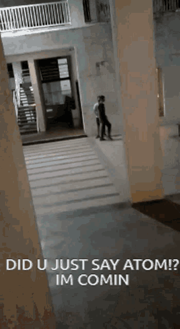 a man standing in a hallway with the words did u just say atom im comin