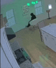 a person is sitting in a chair in a kitchen with a sign on the wall that says stay inside no weed