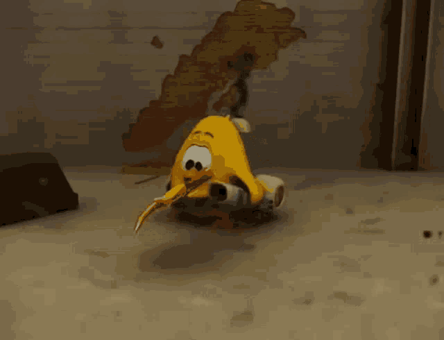 a yellow cartoon character is sitting on a scooter in front of a wall .