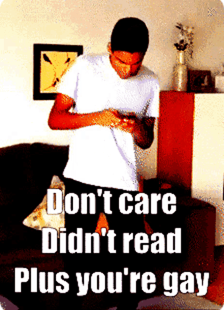 a man standing on a couch with the words " don t care didn t read plus you 're gay