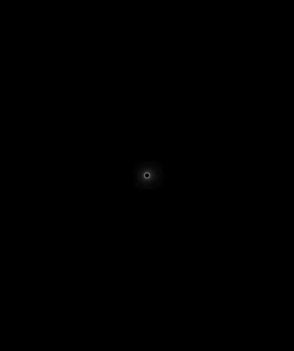 a black circle with a white ring around it on a dark background