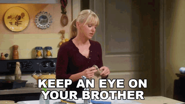a woman in a kitchen with the words " keep an eye on your brother "
