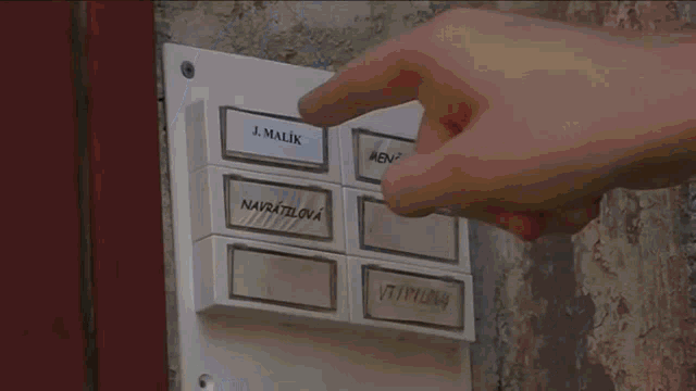 a person pressing a button that says j. malva on it