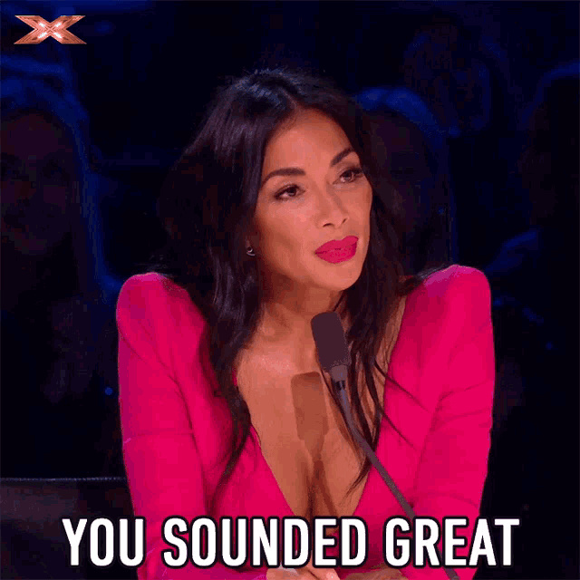 a woman speaking into a microphone with the words you sounded great behind her