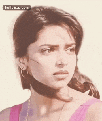 a close up of a woman 's face with a slight smirk on her face .