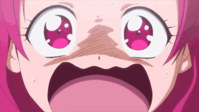 a close up of a girl 's face with a surprised expression