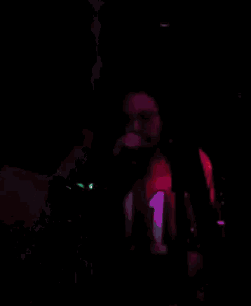 a man singing into a microphone wearing a shirt with the number 1 on it