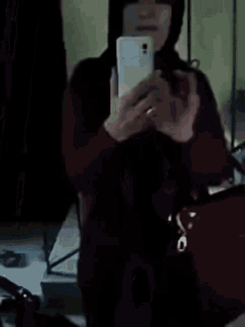 a blurry picture of a person standing in front of a mirror