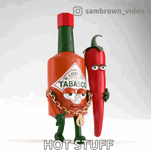 a bottle of tabasco is chained to a pepper