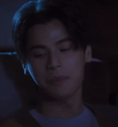 a close up of a man 's face in a dark room .