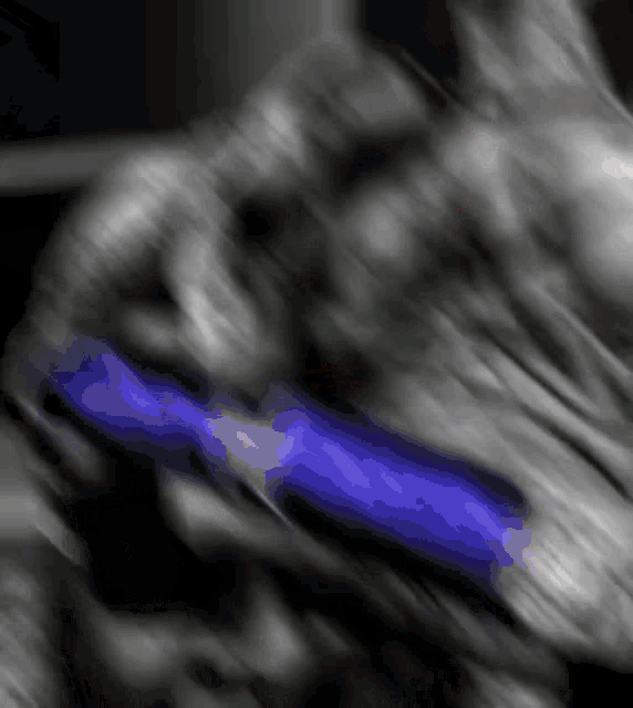 a blurry picture of a person holding a blue object in their hand