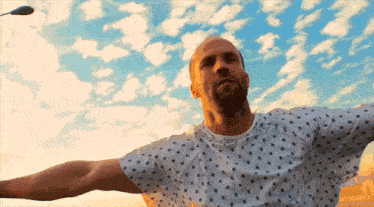 a man in a hospital gown is looking up at the sky