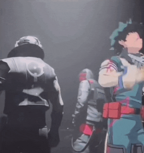 a group of people are standing in a dark room .